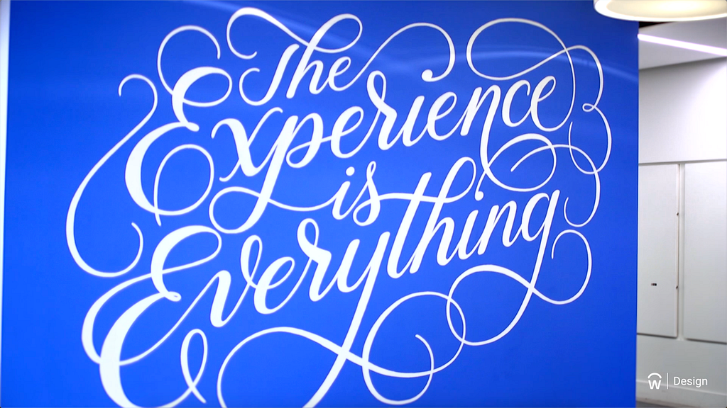 Image of a wall mural reading The Experience is Everything