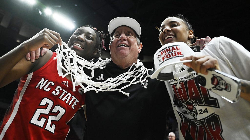 NC State players, Saniya Rivers and Aziaha James, pose for a picture with coach Wes Moore.