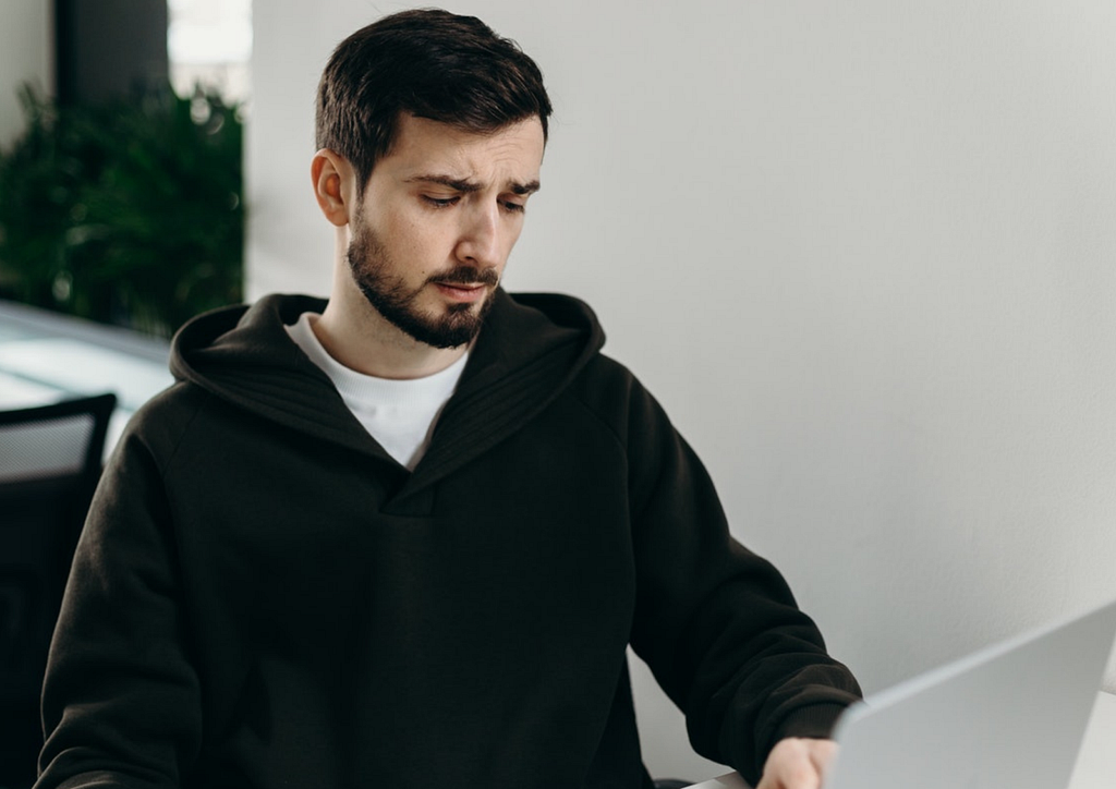 a man sitting in front of his laptop