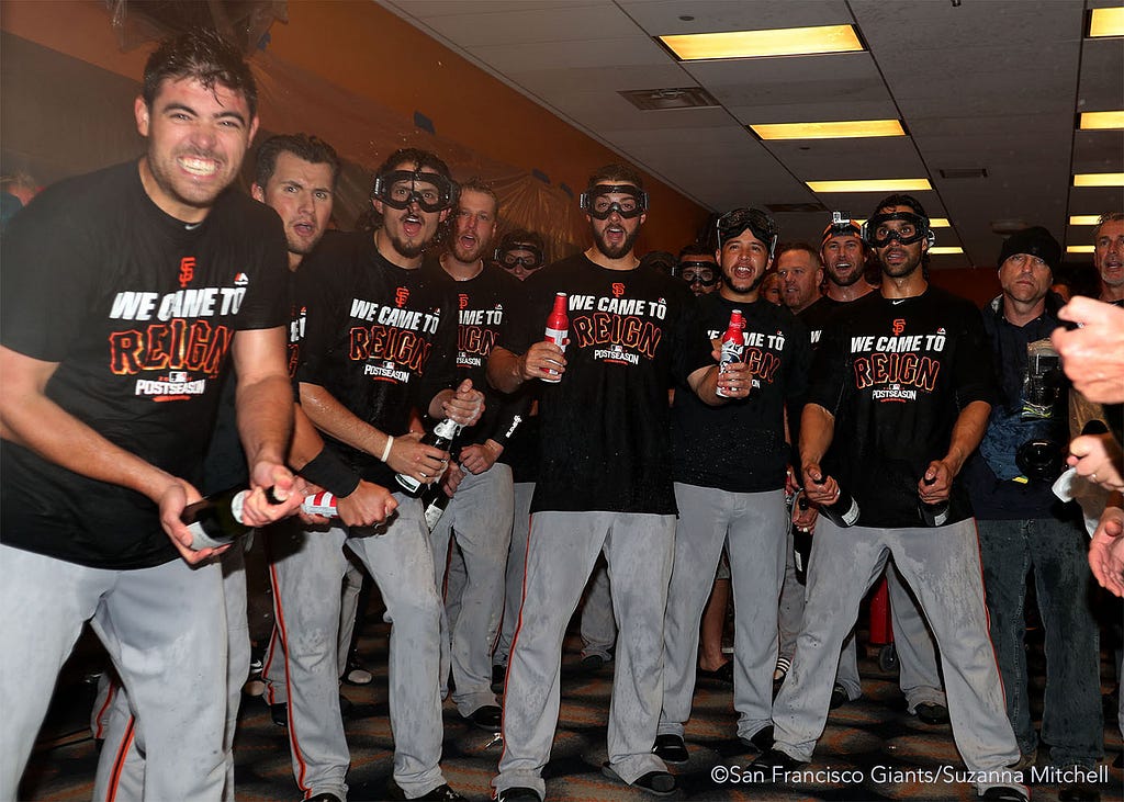 The team waits for Conor Gillaspie to enter the clubhouse.