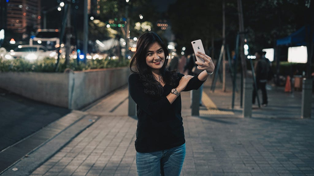 Happy woman taking a selfie.