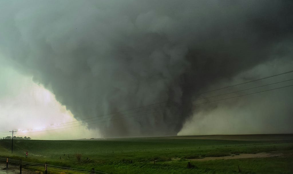 a large tornado heading across farmland