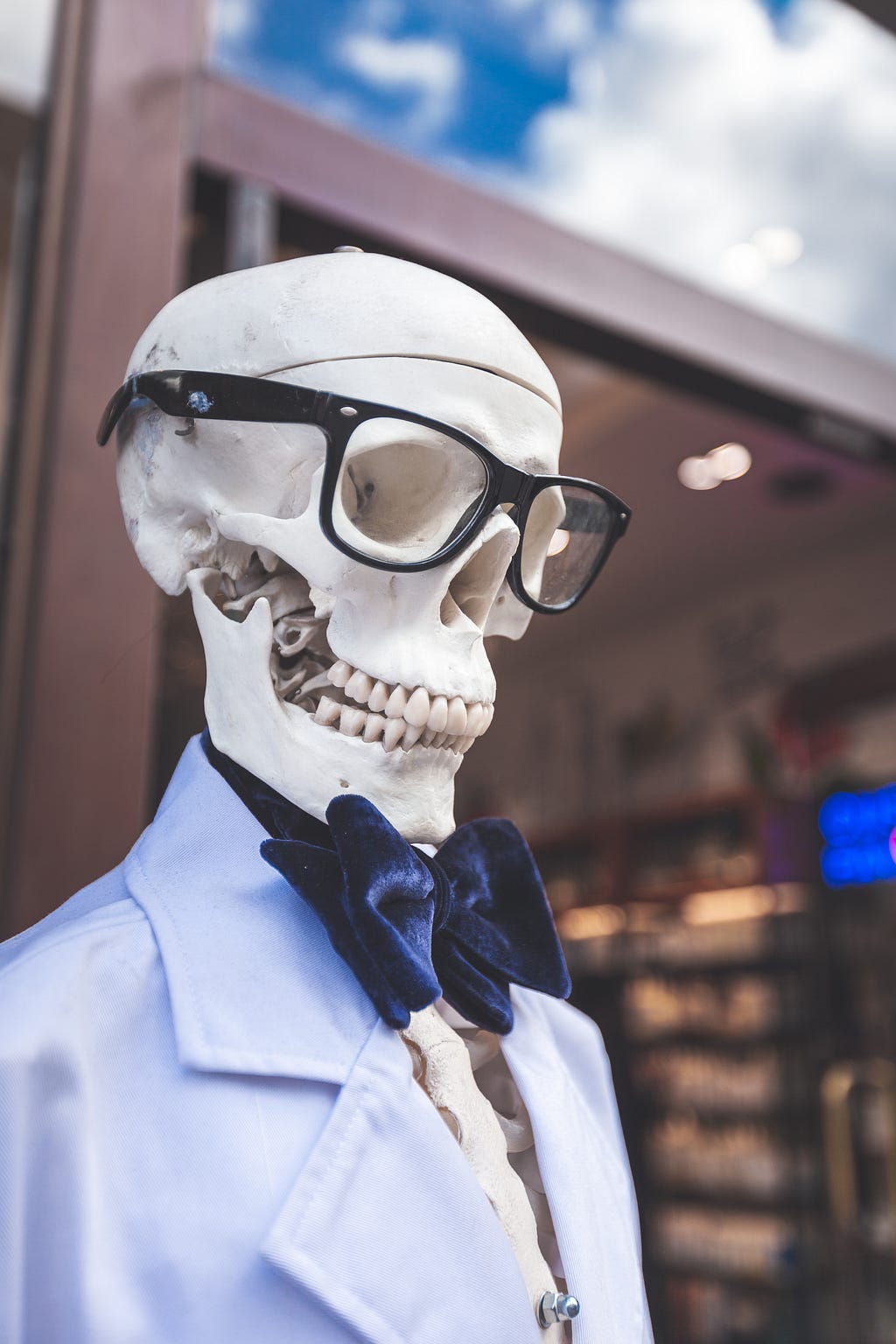 A skeleton in light blue  suit wearing spectacles.