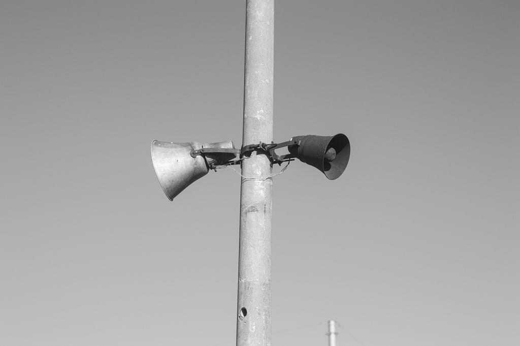 a loudspeaker on a pole making announcements