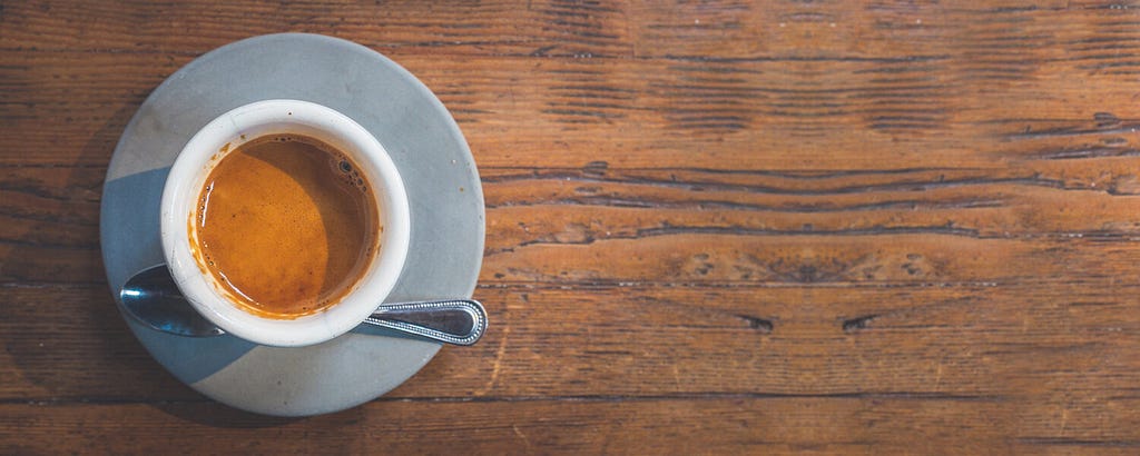 A cup of coffee on an old dish