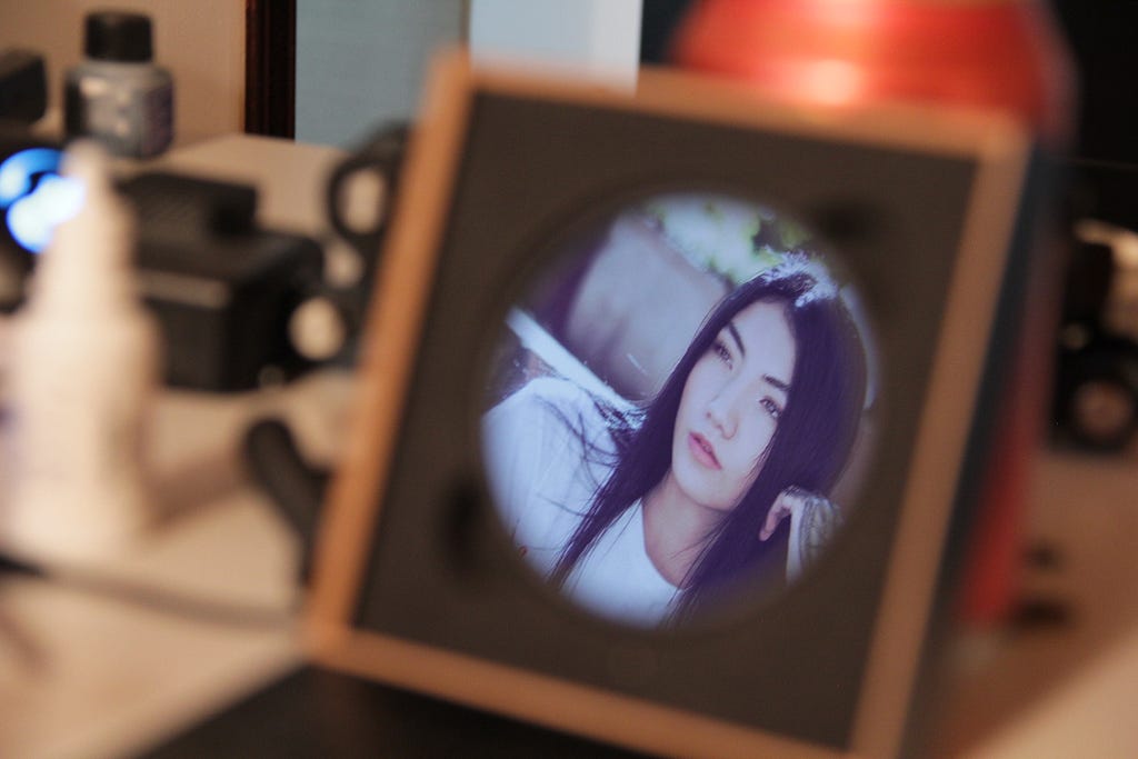 A framed photograph of a pretty young woman.