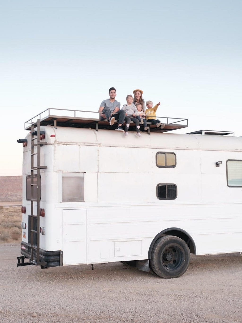 The family on top of the bus.