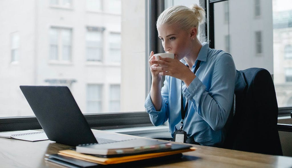 Woman drinking a coffee and reading ten abilities and skills for professionals