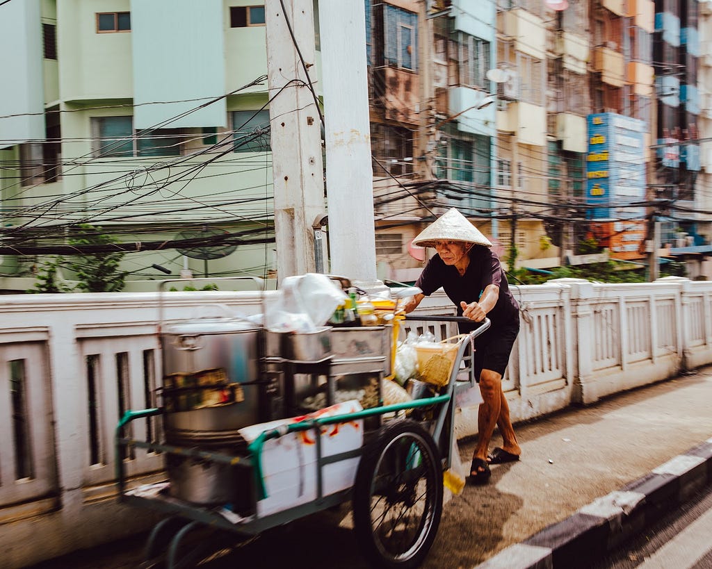 Man pushing a food cart