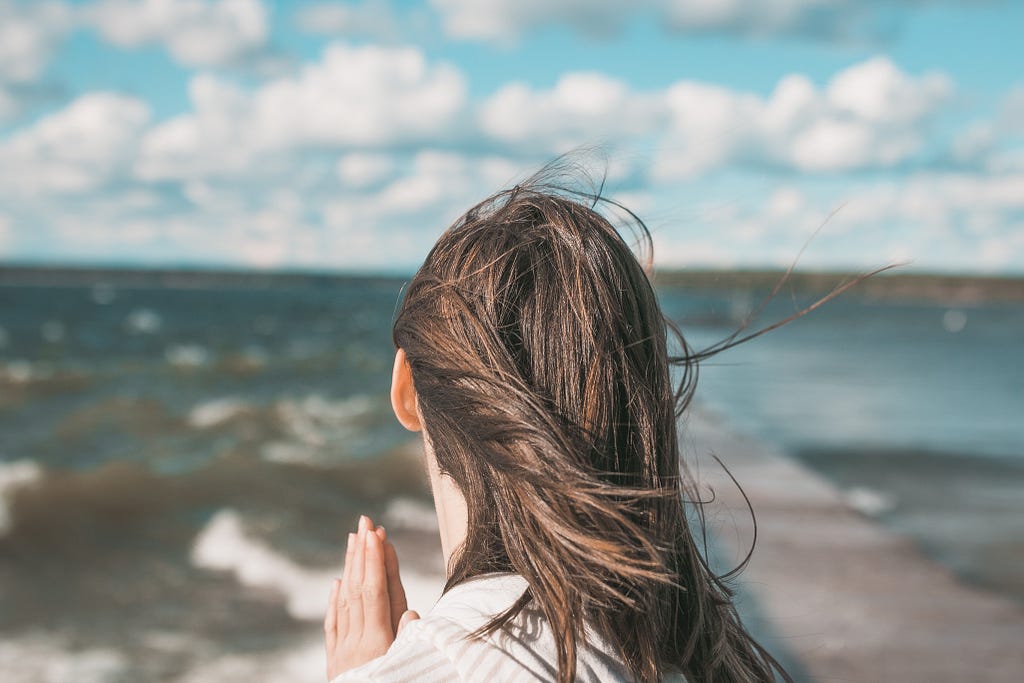 Image of girl praying in the wind