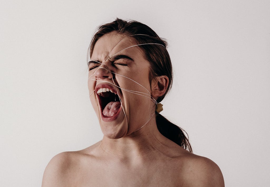 Image of a woman yelling out of frustration