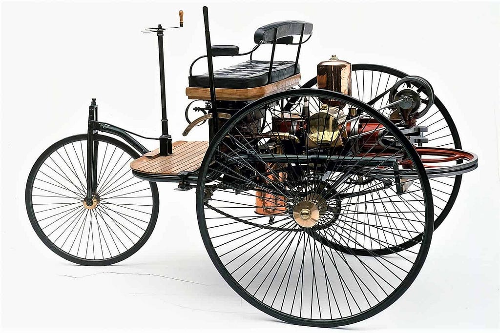 The 1886 Benz Patent-Motorwagen didn’t have a steering wheel; it had a primitive steering tiller. Today, “vibe coding” and manual prompting are our steering tillers. They are clunky, early controls used before we standardized the modern “steering wheel” of Spec Driven Development. (image source: DaimlerChrysler)