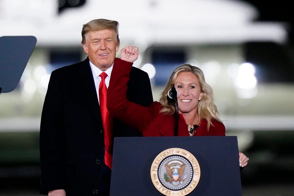 Greene speaks beside then-President Donald Trump at a campaign rally in Dalton, Georgia, on January 4, 2021.