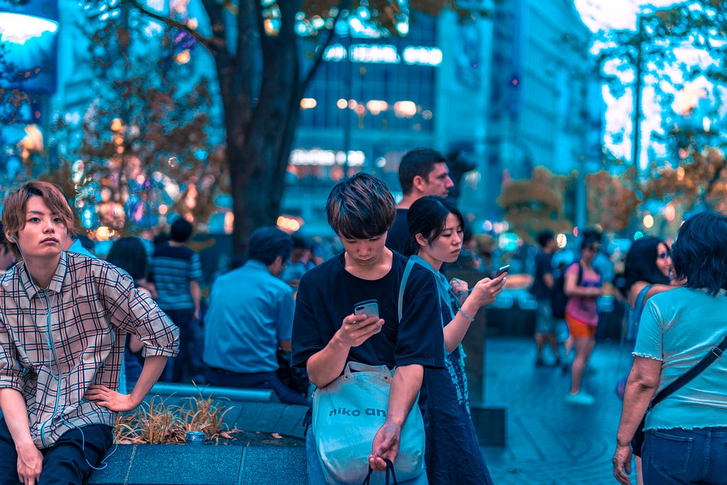 A person looking at a phone in a public space