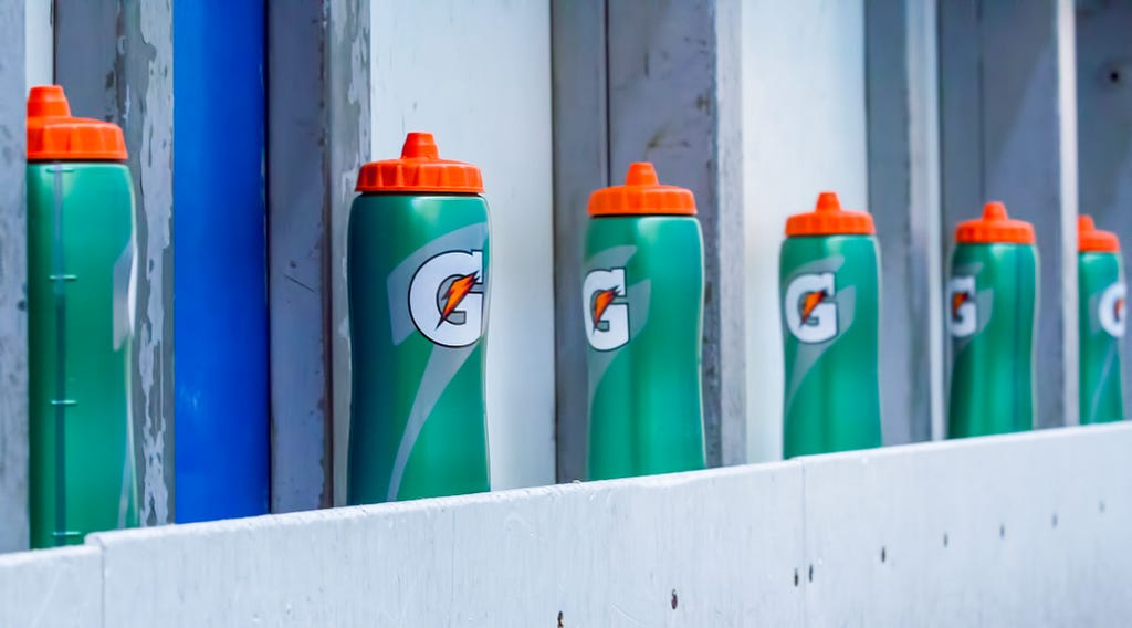 Green Gatorade water bottles stacked in a line