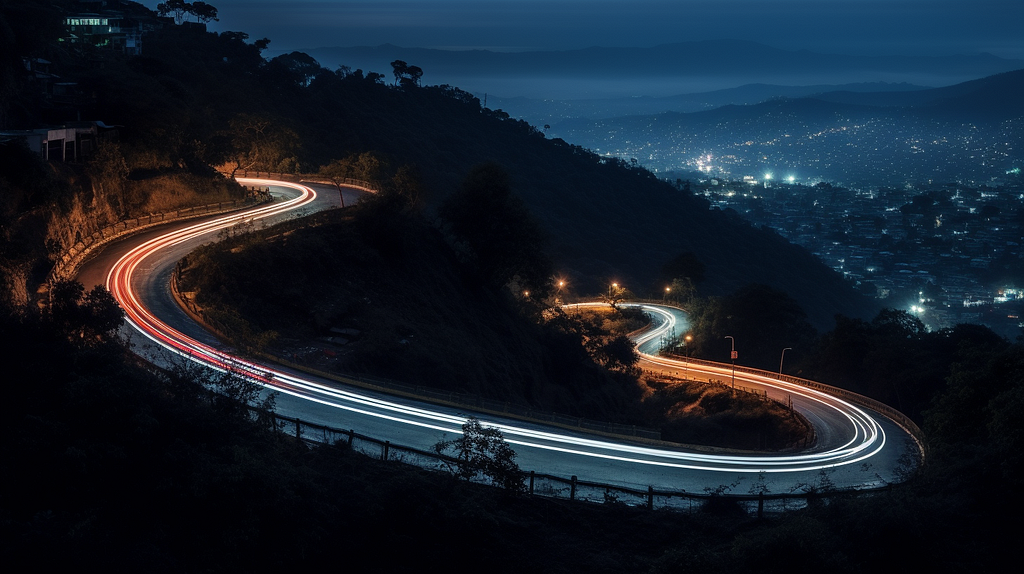 Trailing lights of cars on a winding ghat road on a hill, shot using a Sony Alpha a17 III mirrorless camera, with color-gel lens, aperture f/1.4, shutter speed 5, long exposure, ISO 1600 (generated by Midjourney)