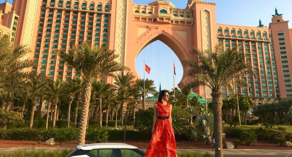 Digital nomad standing in front of Atlantis Hotel, Palm Jumeirah in Dubai