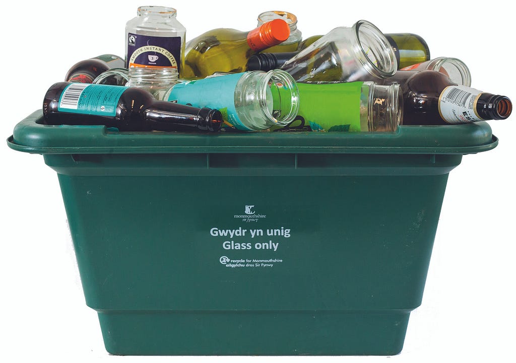 Recycling box full of glass bottles.