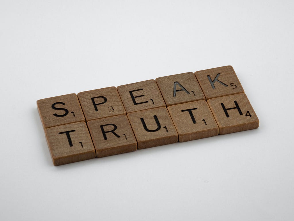 Scrabble pieces that spell “speak truth”