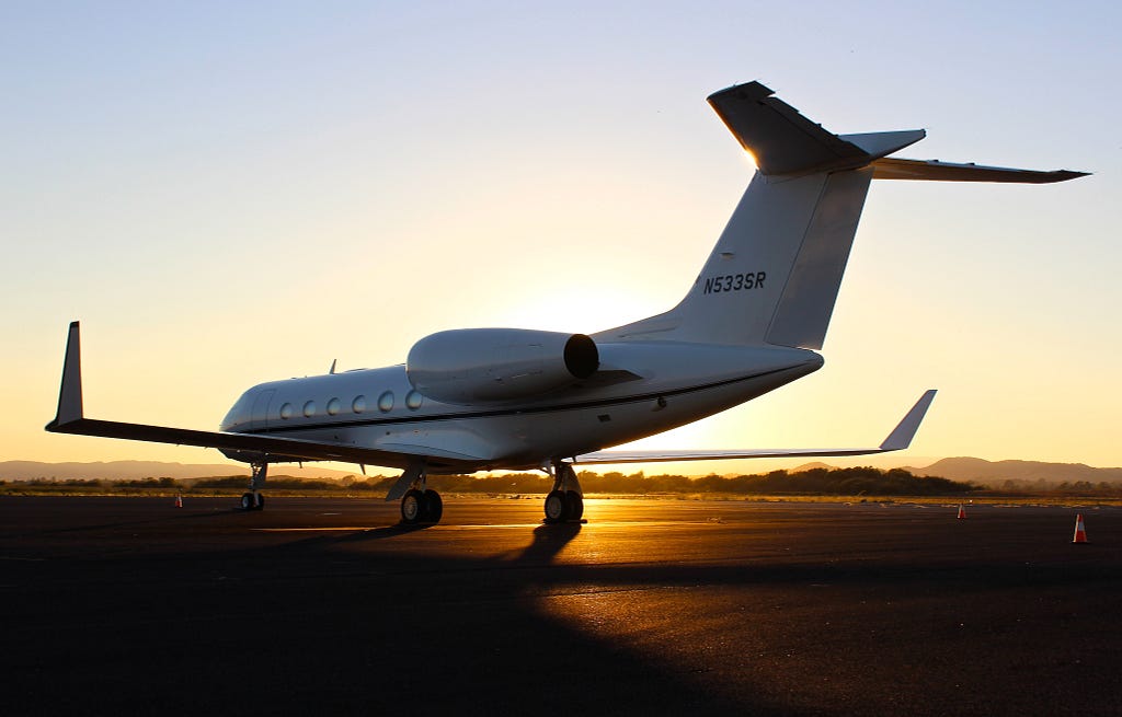 Airplane on the runway during sunset