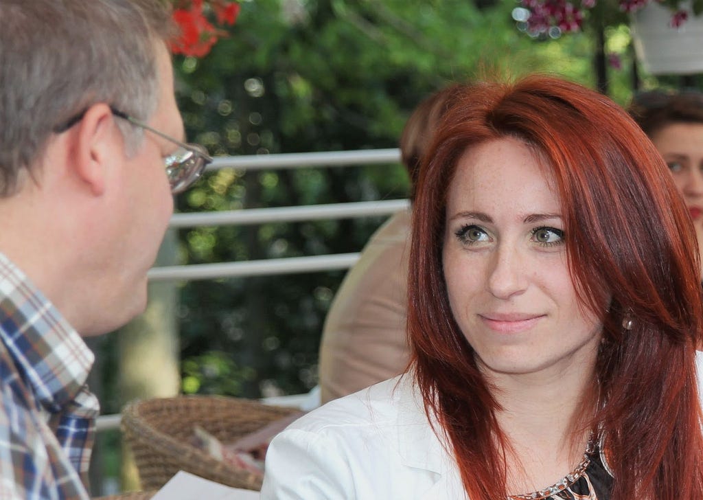 A woman smiling at a man