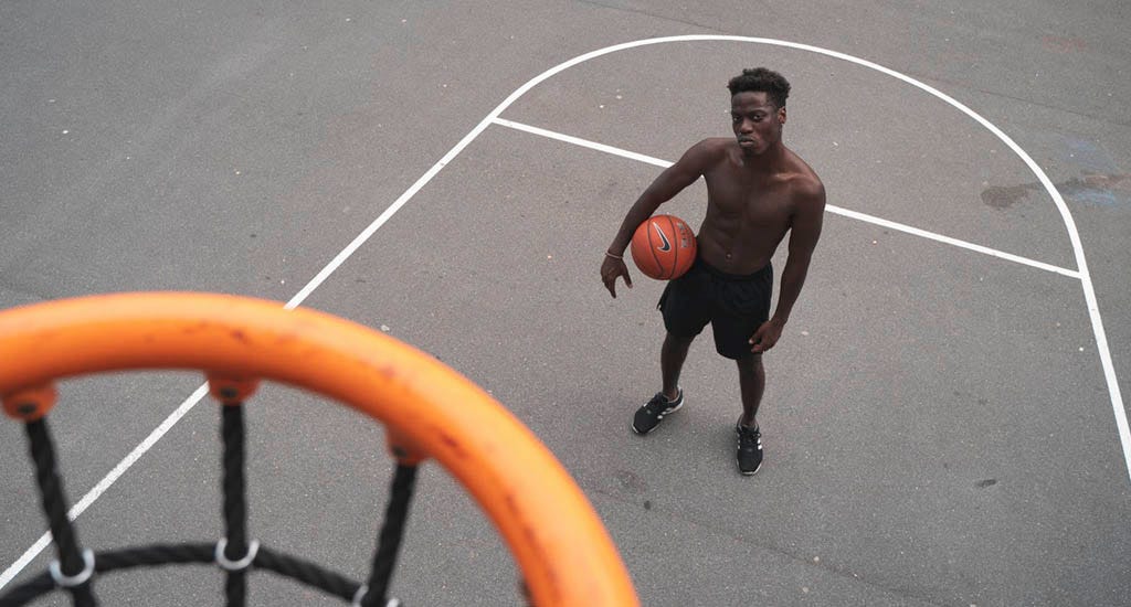 Basketball player looking up at hoop