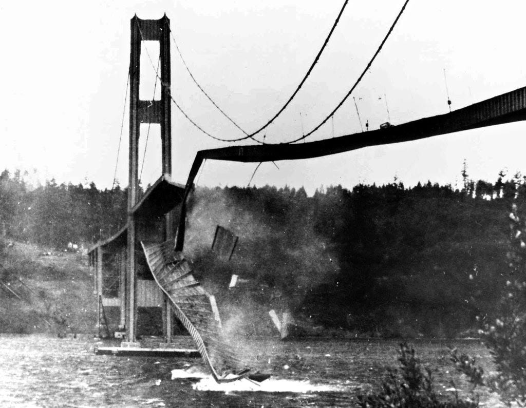 black and white image of a broken bridge