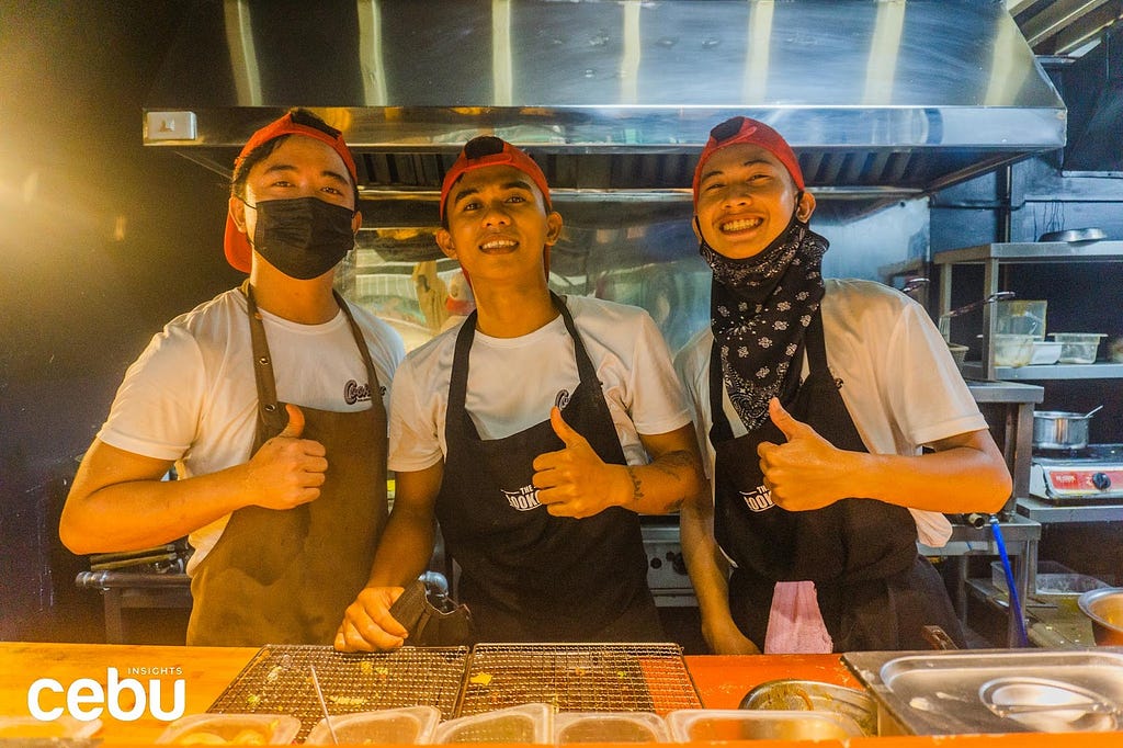 Food servers smiling for the camera