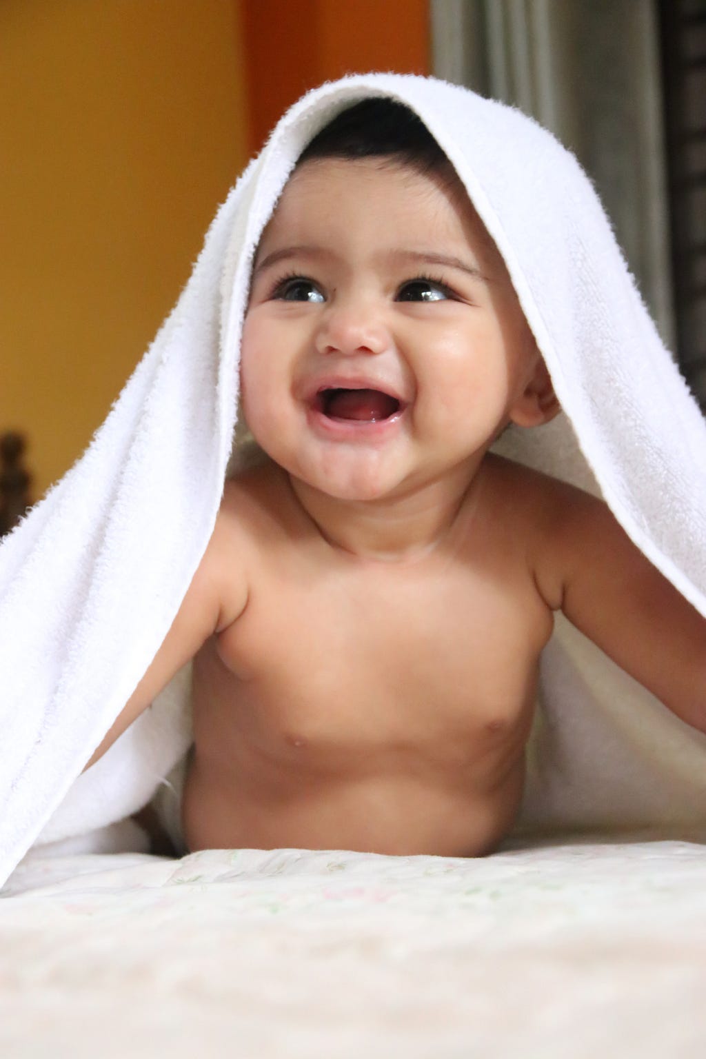 smiling cute baby under towel