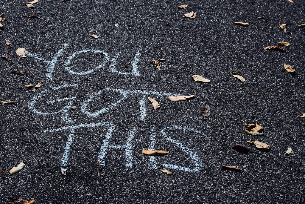 a writing on the floor that says: ‘You Got This!’