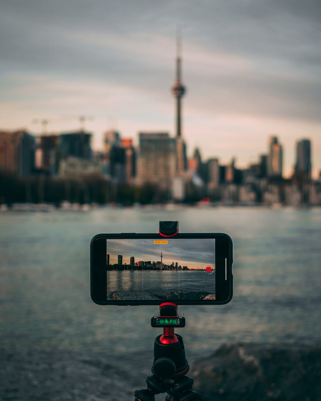 iphone taking video of large city across a body of water