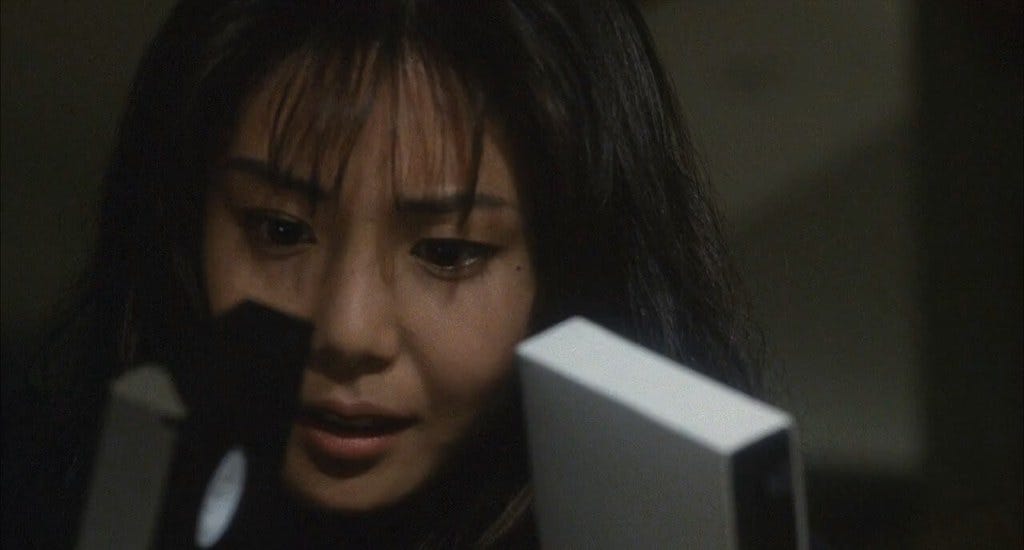 Asakowa inspects the tapes in Ringu (1998)