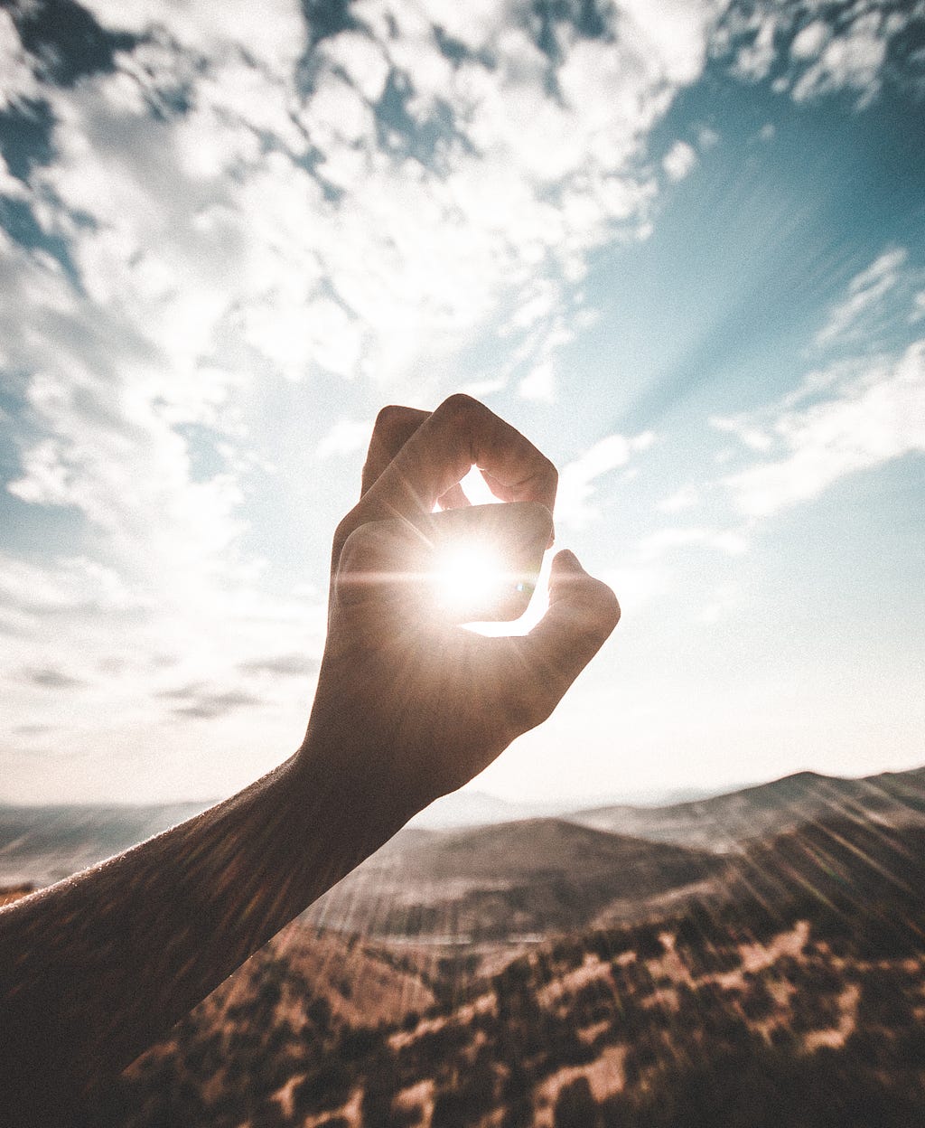 sunshine through someone’s fingers