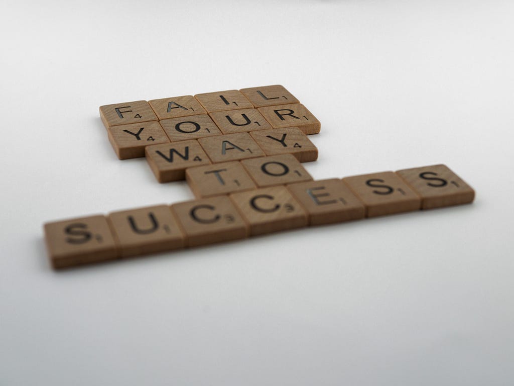 Scrabble blocks that read, “Fail your way to success”