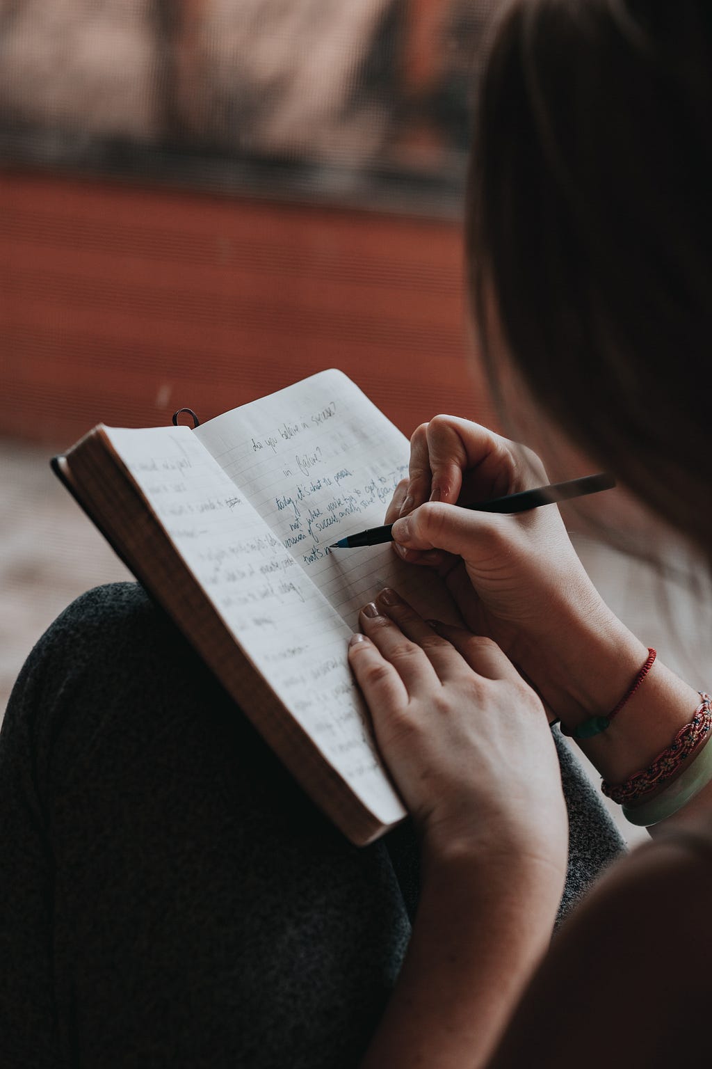 someone who is writing in her notebook