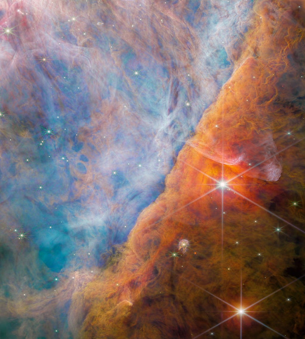 In a part of the Orion Nebula known as the Orion Bar (pictured), dense molecular clouds envelope newborn stars. In this false-color image, the reddish-brown clouds are denser than the blue ones.