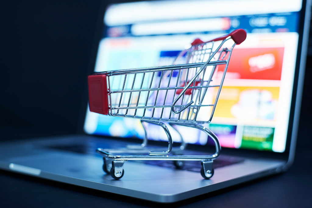 A sleek laptop displaying a vibrant website with clickable product images and a miniature shopping cart. This image represents the convenience of shoppable content, allowing users to browse and virtually “add to cart” directly from the website.