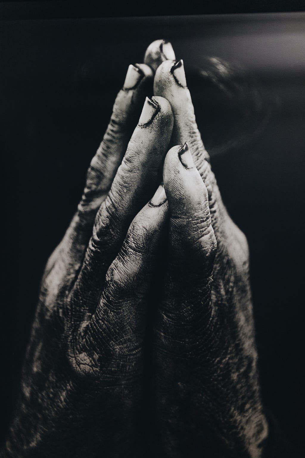 Black and white photo of praying hands