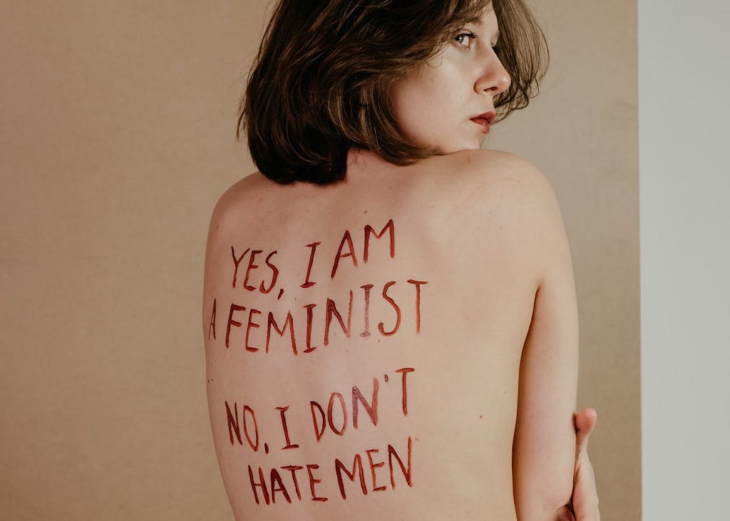 a woman with red words painted on her back