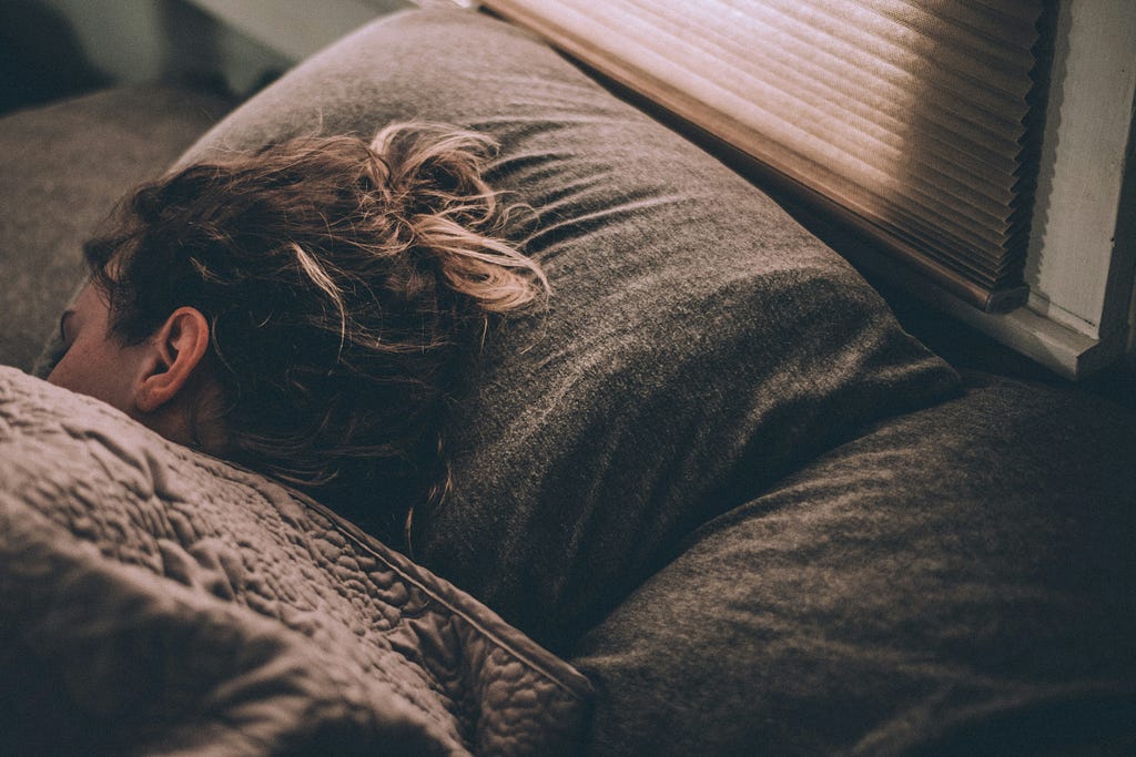 Woman sleeping in her bed