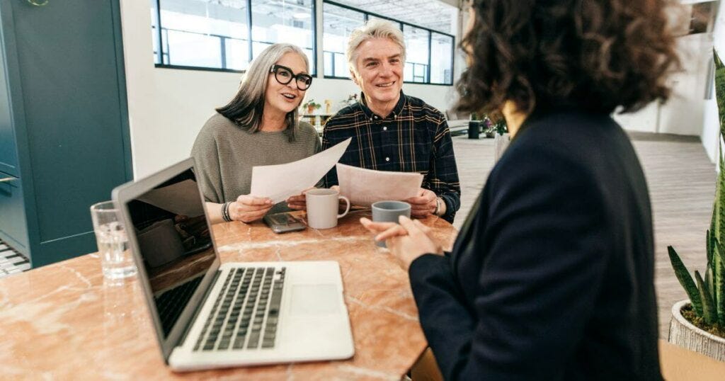 A couple consulting with an estate planning attorney in an office