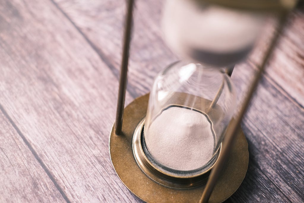 Hourglass with sand flowing down