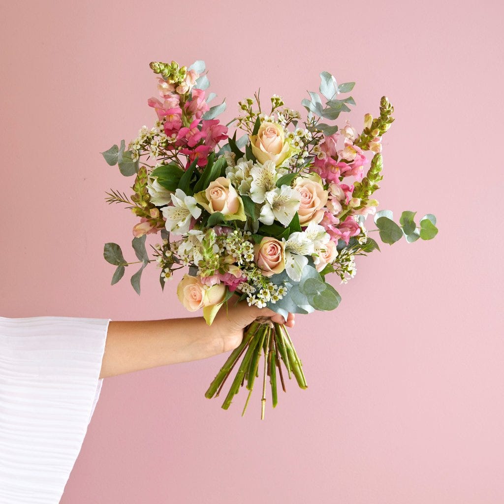 Bouquet of flowers against a soft pink backdrop