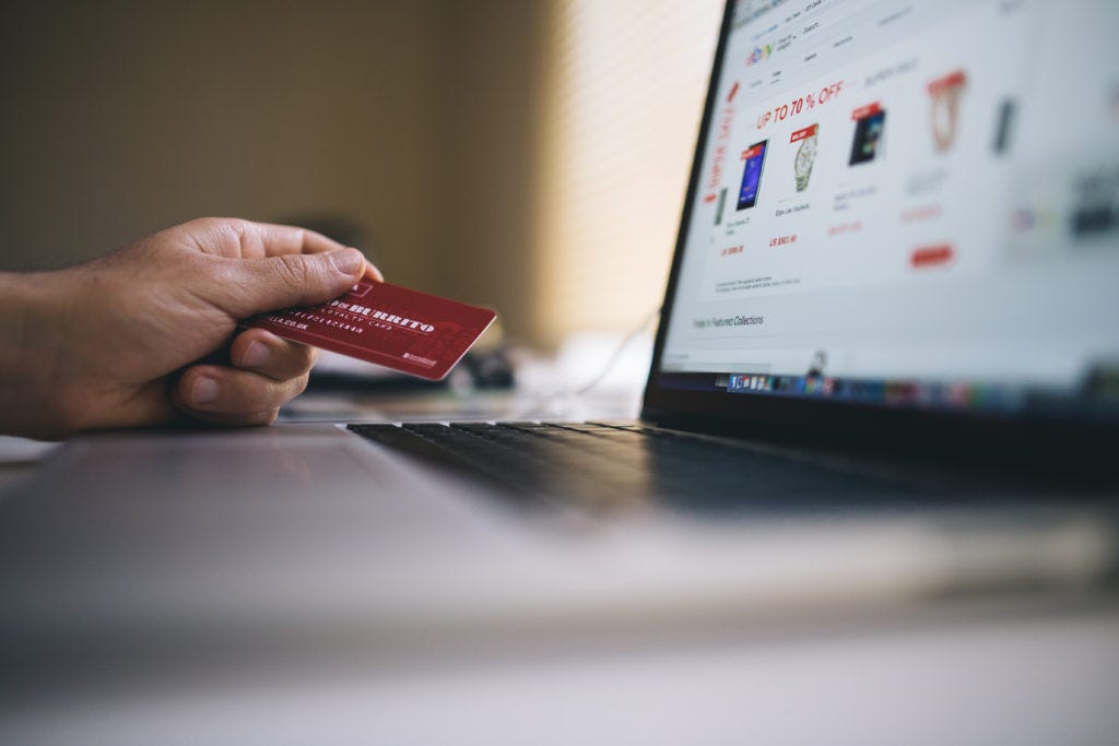 man-holding-credit-card-and-shopping-online