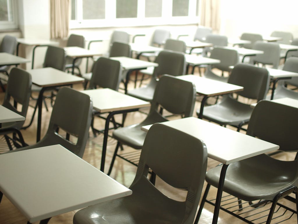Rows of empty seats and desks as in an exam hall