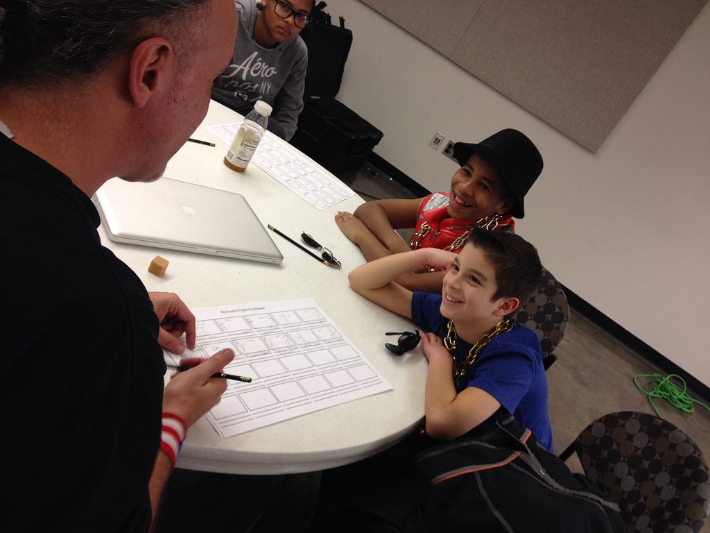 Popmaster Fabel shares his storyboard with students during our recent workshop with the Scratch team.