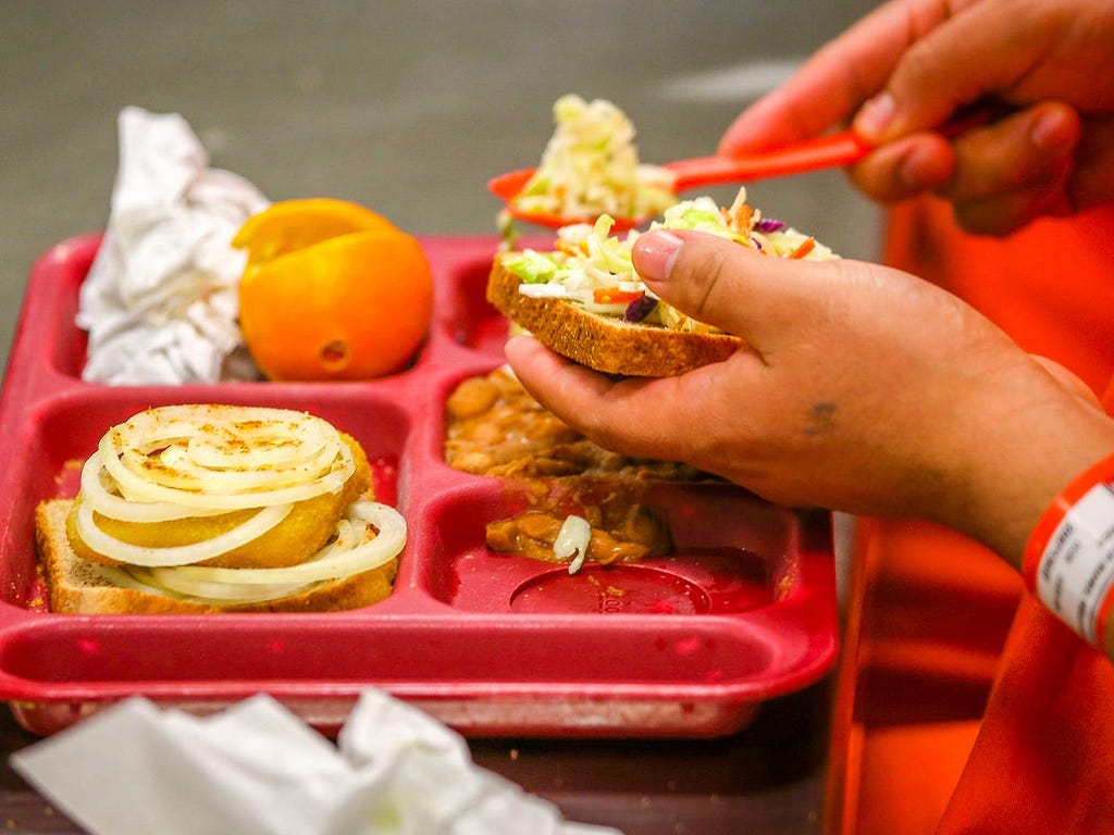 Immigrant detainees eat lunch at the Adelanto Detention Facility in California in 2013.