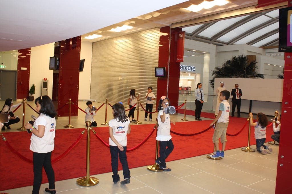 Kid journalists awaiting the arrival of guests at the red carpet.