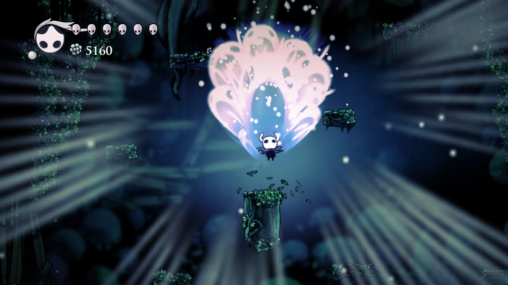 The player in Hollow Knight uses the Howling Wraiths spell, creating a blast of white energy directly above them.
