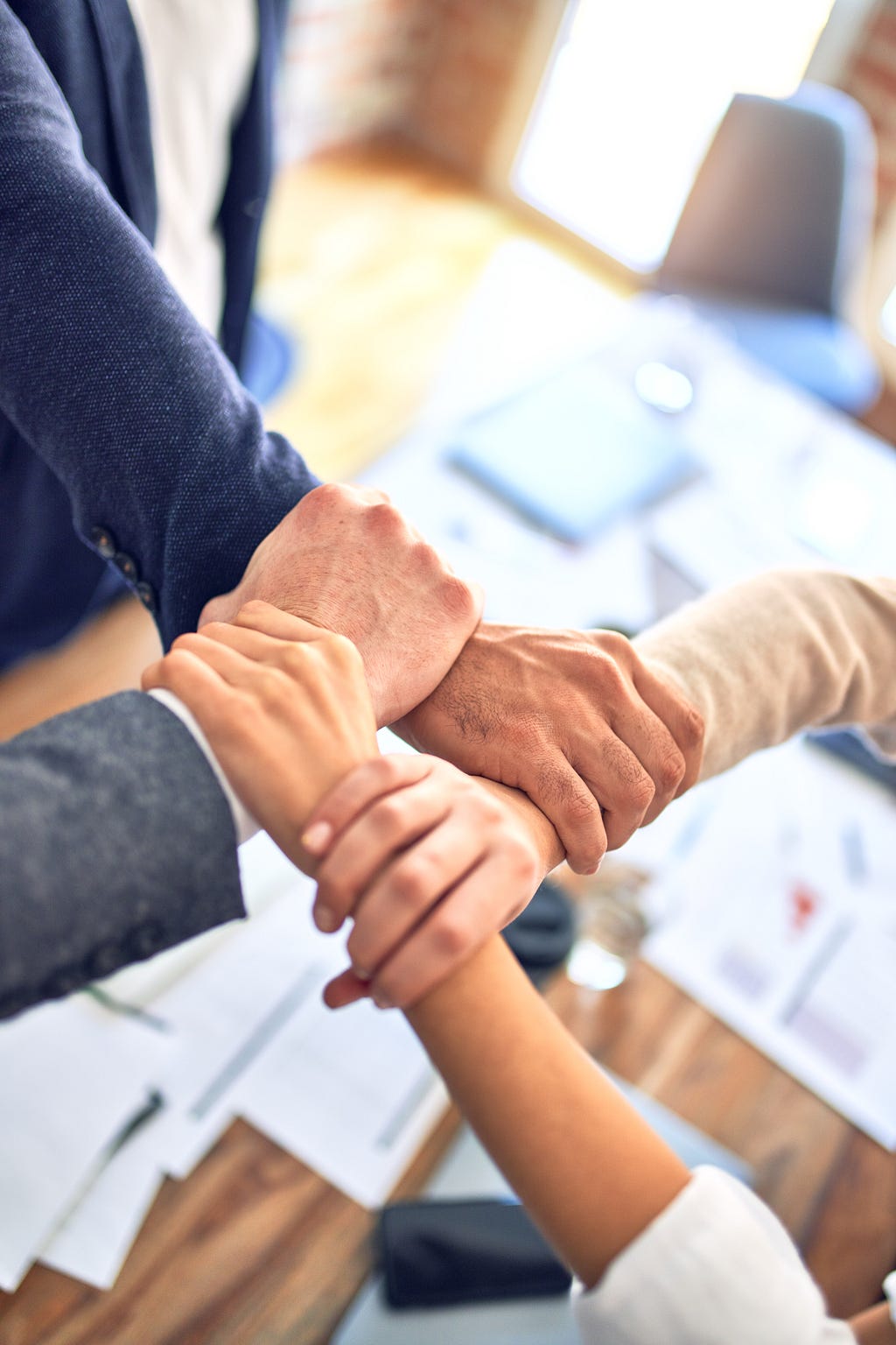 A group of people holding hands; a community